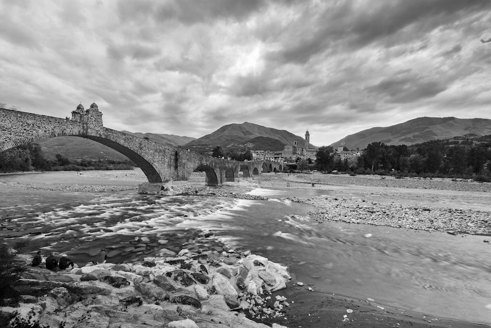 grayscale photo of bridge over river