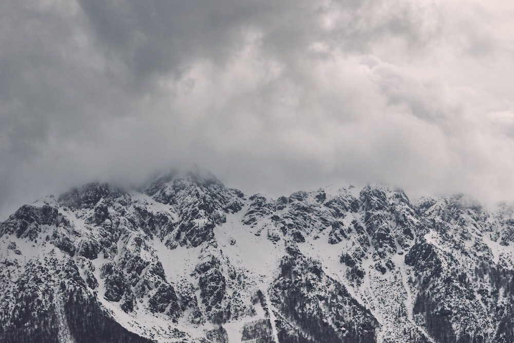 snow covered mountain under cloudy sky during daytime