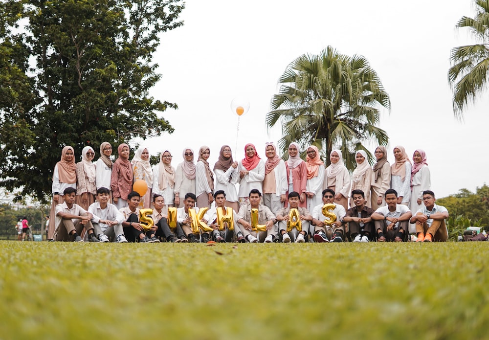 people in yellow shirt on green grass field during daytime