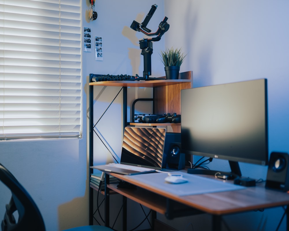 black flat screen computer monitor on brown wooden computer desk