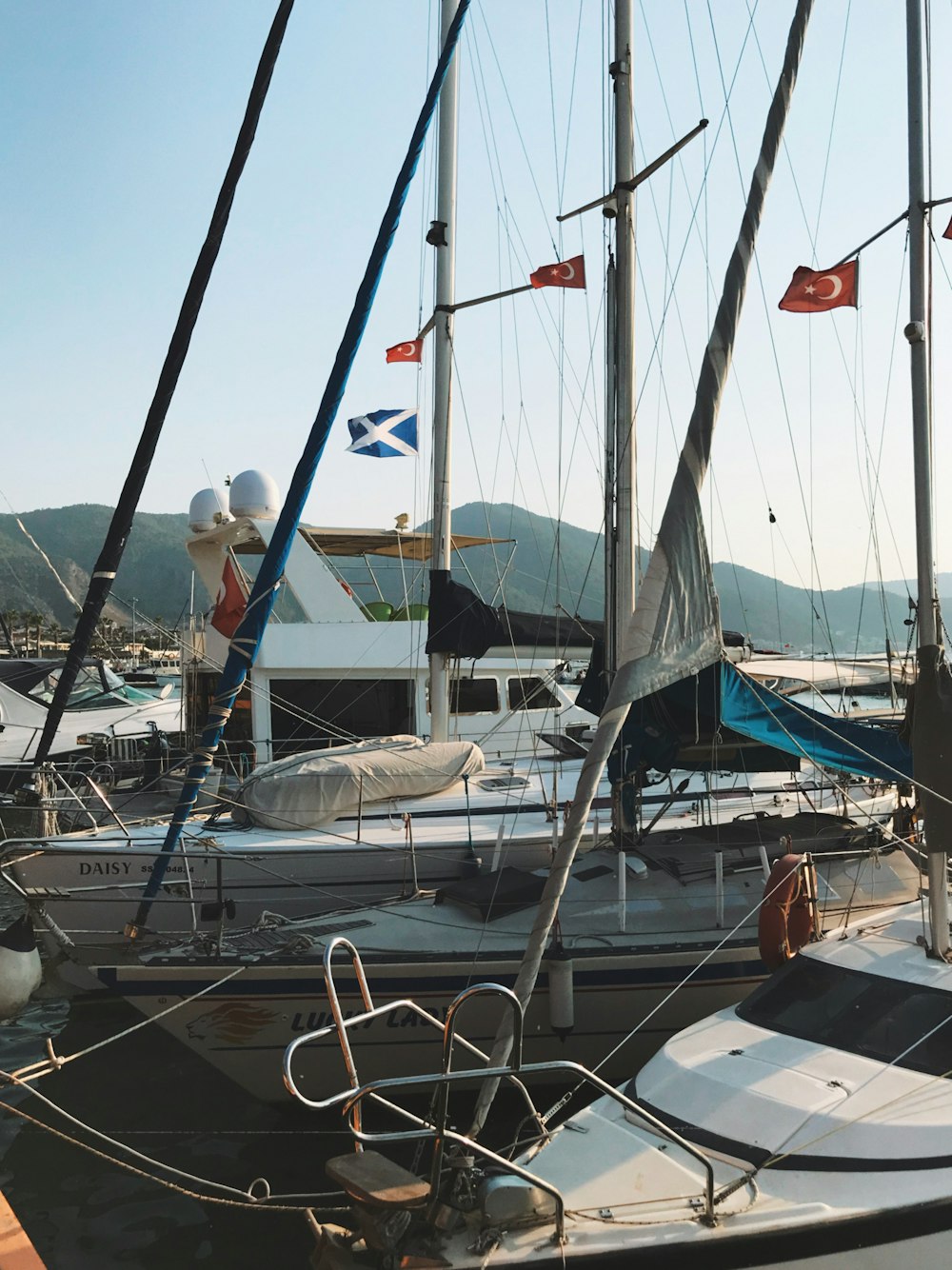 woman in blue t-shirt and white shorts standing on white boat during daytime