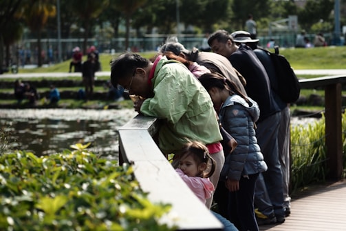 people standing on green grass field during daytime