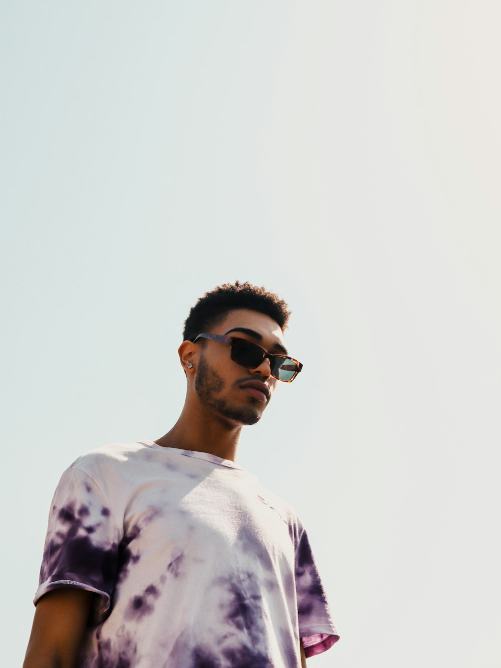 man in white and black crew neck shirt wearing black sunglasses