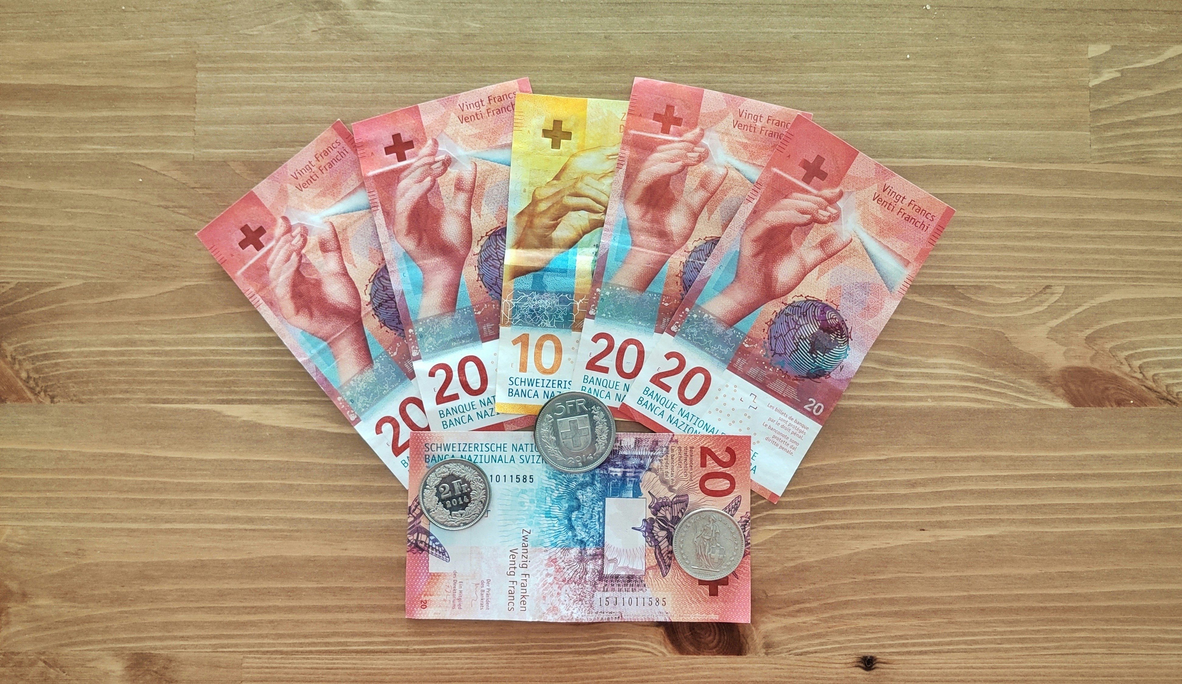 10 and 50 banknotes on brown wooden table