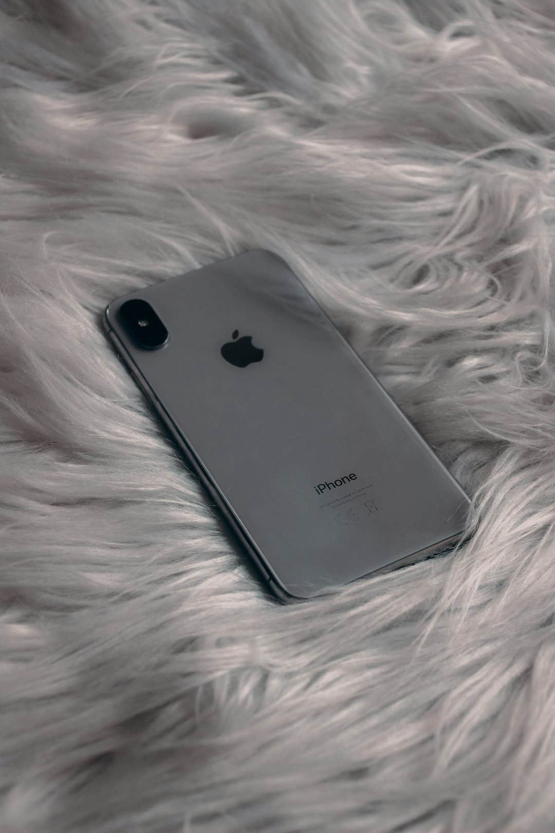 black iphone 7 plus on white textile