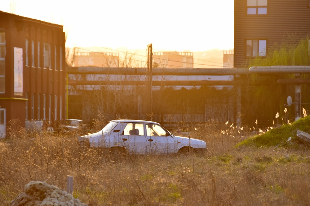 white sedan parked near brown building during daytime