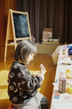 girl in black and white sweater sitting on floor