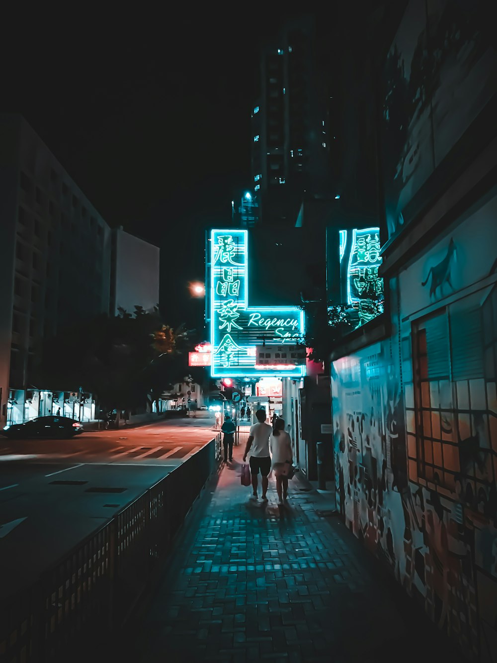 people walking on sidewalk during night time