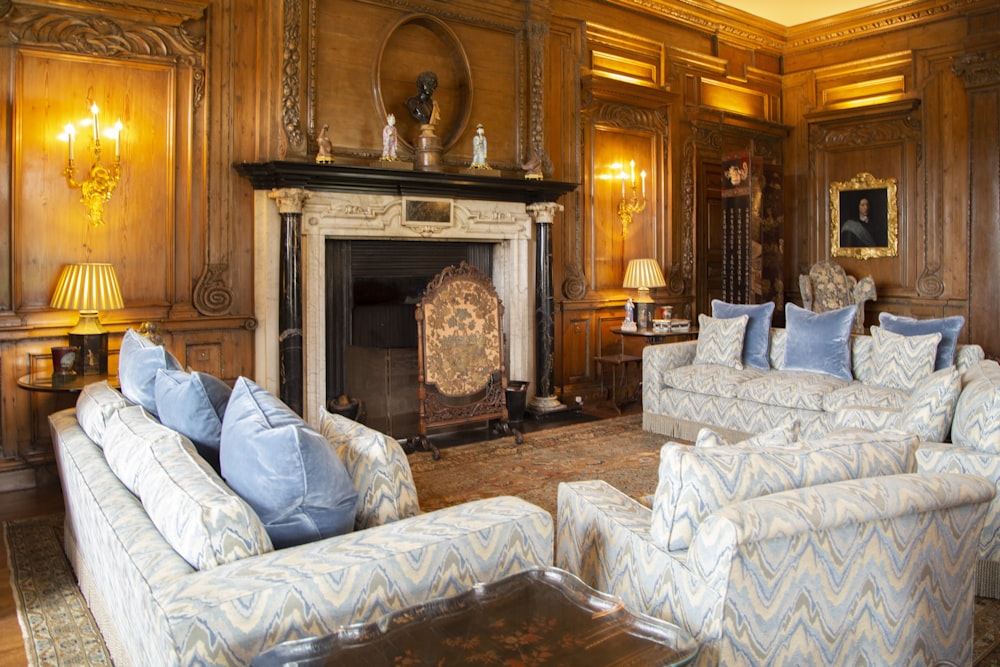 white and gray floral sofa chair near fireplace