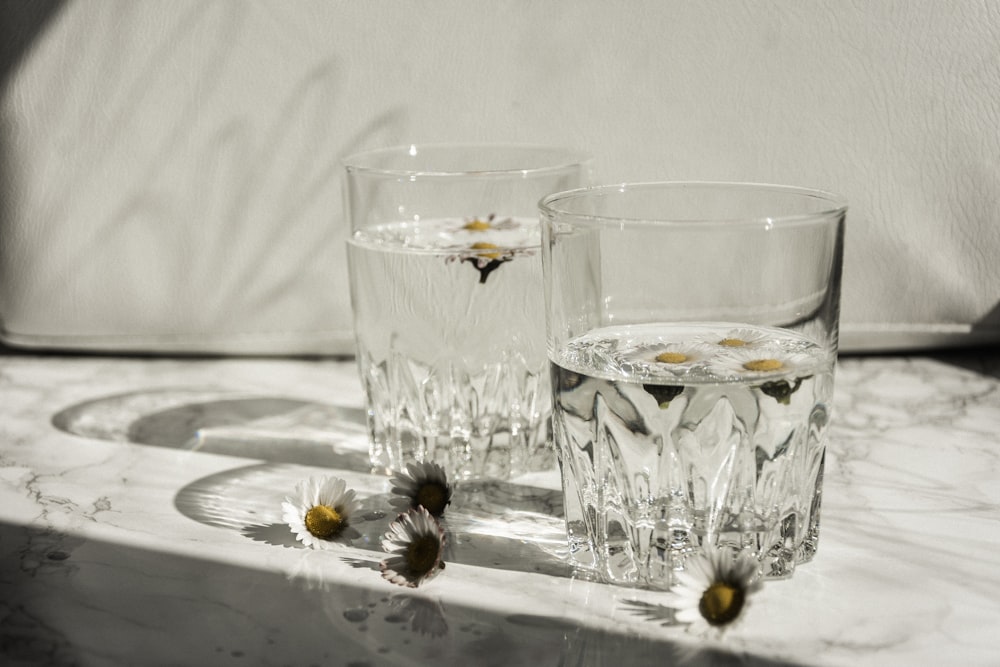 clear drinking glass on white ceramic plate