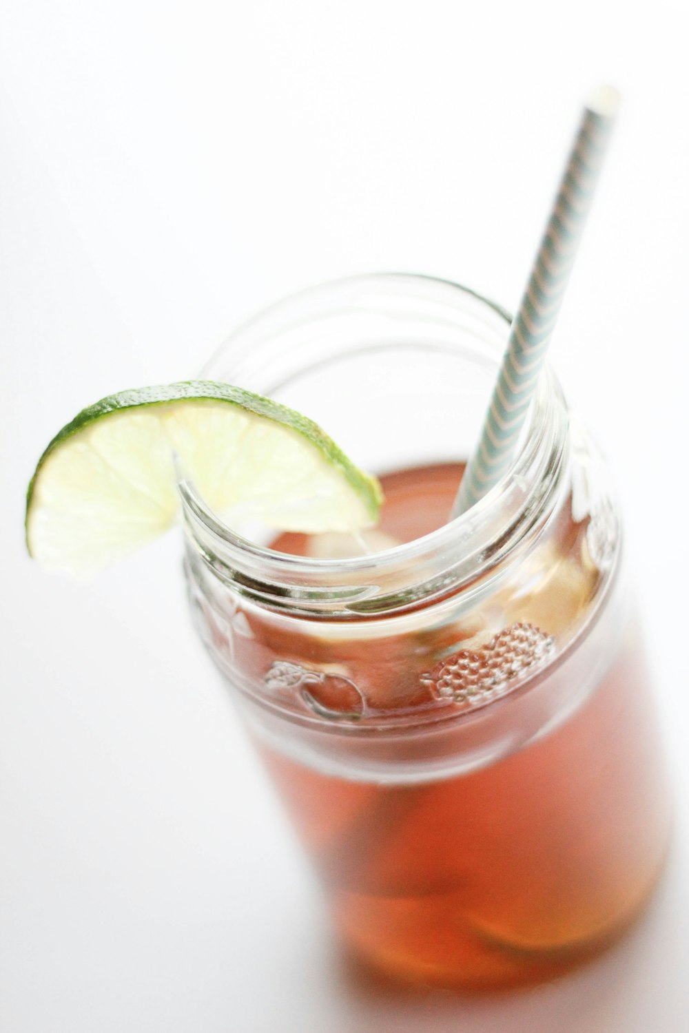 clear drinking glass with sliced lemon and water