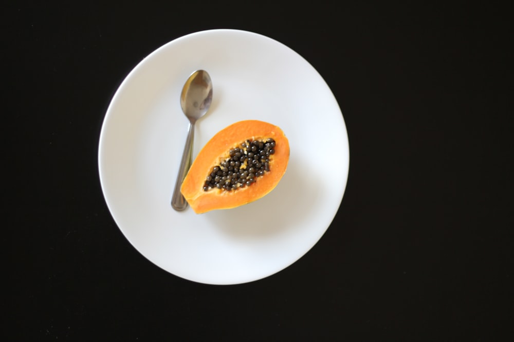 orange fruit on white ceramic bowl