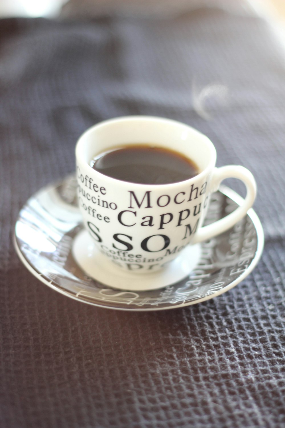 white ceramic cup with saucer on brown wooden table