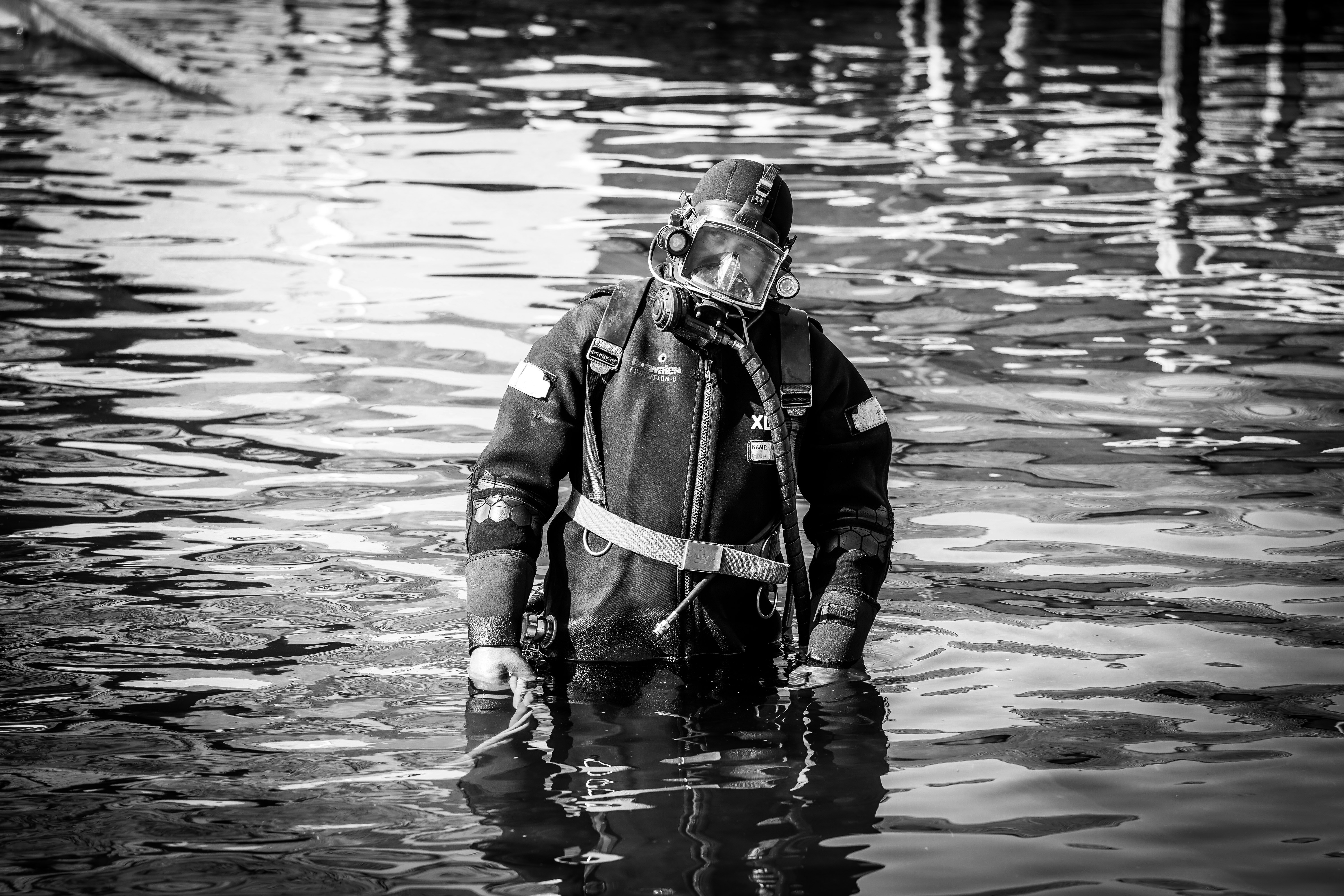 grayscale photo of man in water