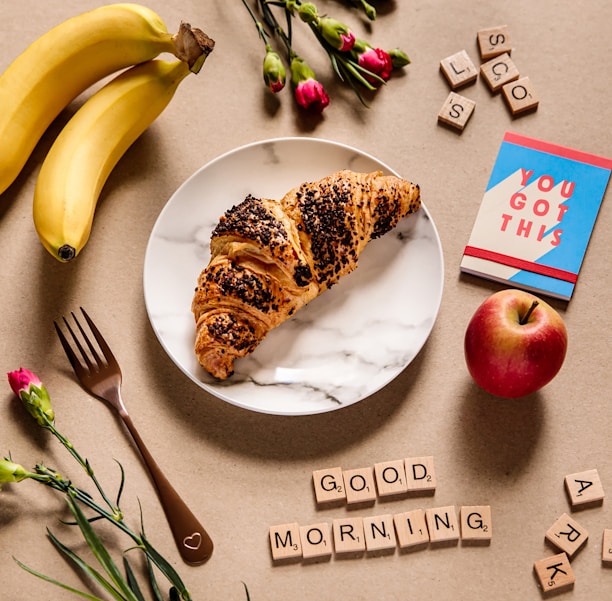 banana fruit and bread on white ceramic plate