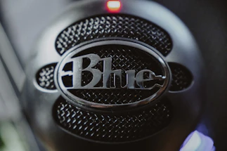 A sleek microphone with blue lighting, symbolizing open conversation.