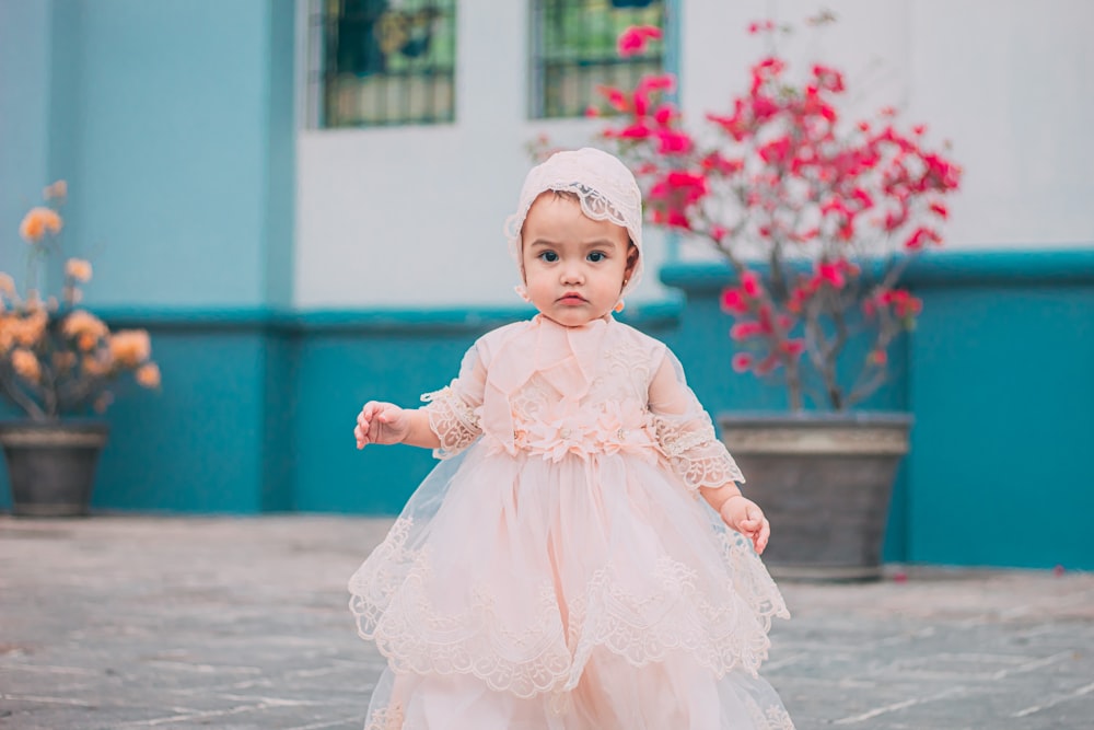 girl in pink dress and white hat