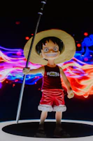 Dynamic vertical card showing a close-up of Luffy in Gear 5 with vibrant red and yellow highlights.