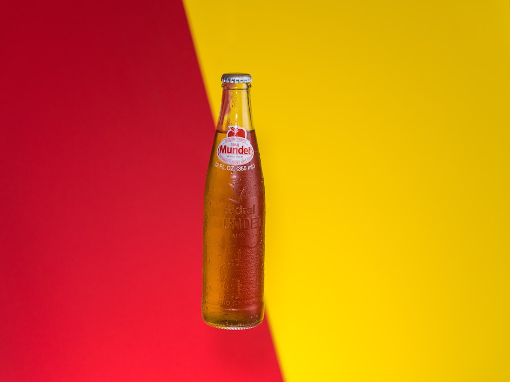 clear glass bottle with orange background