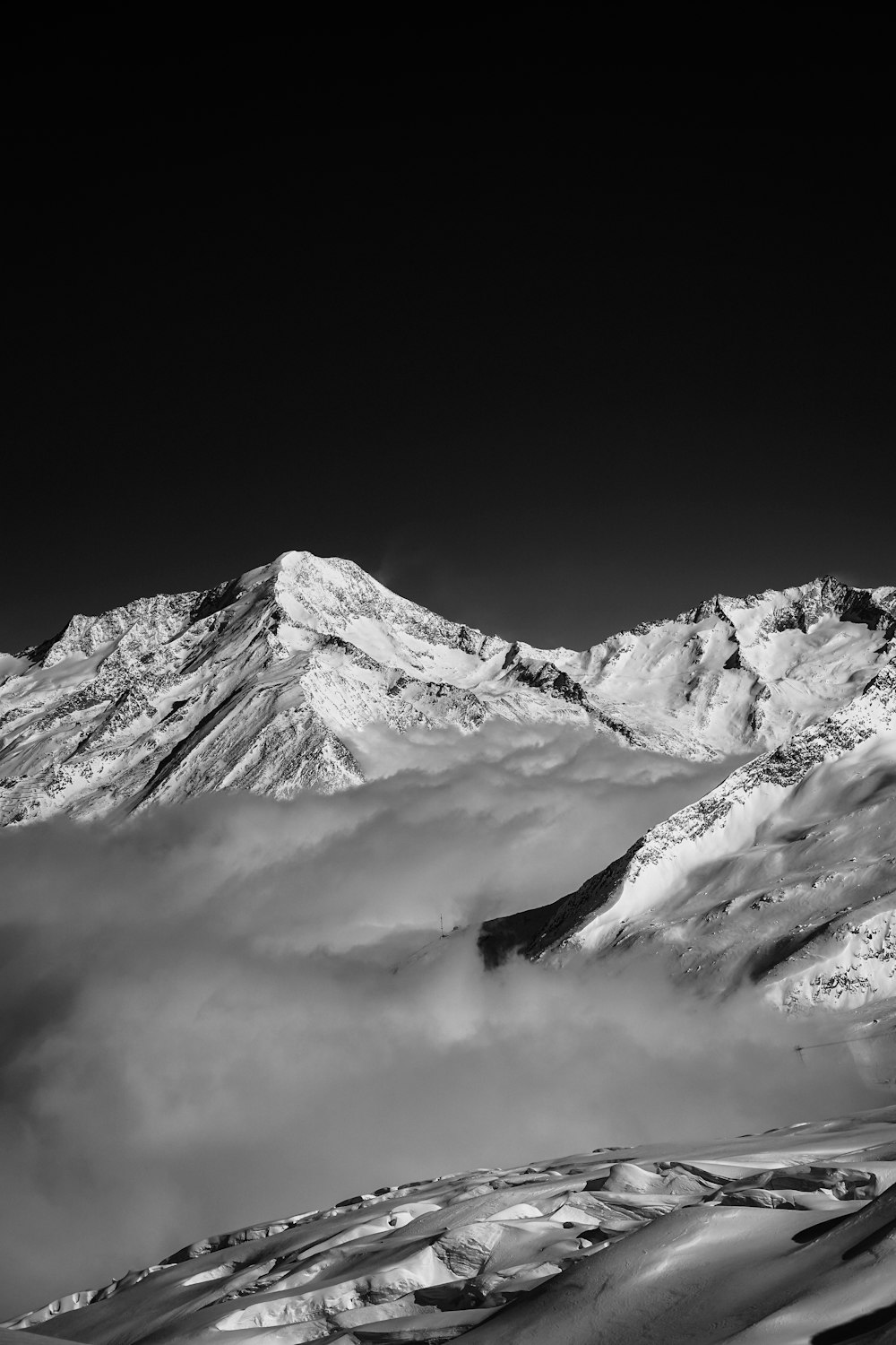 snow covered mountain under cloudy sky