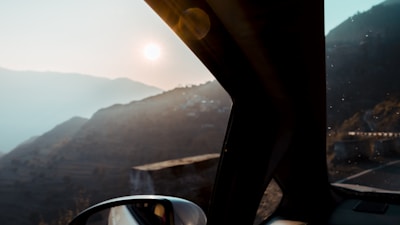 A scenic mountain view captured from the back of the van at sunrise.