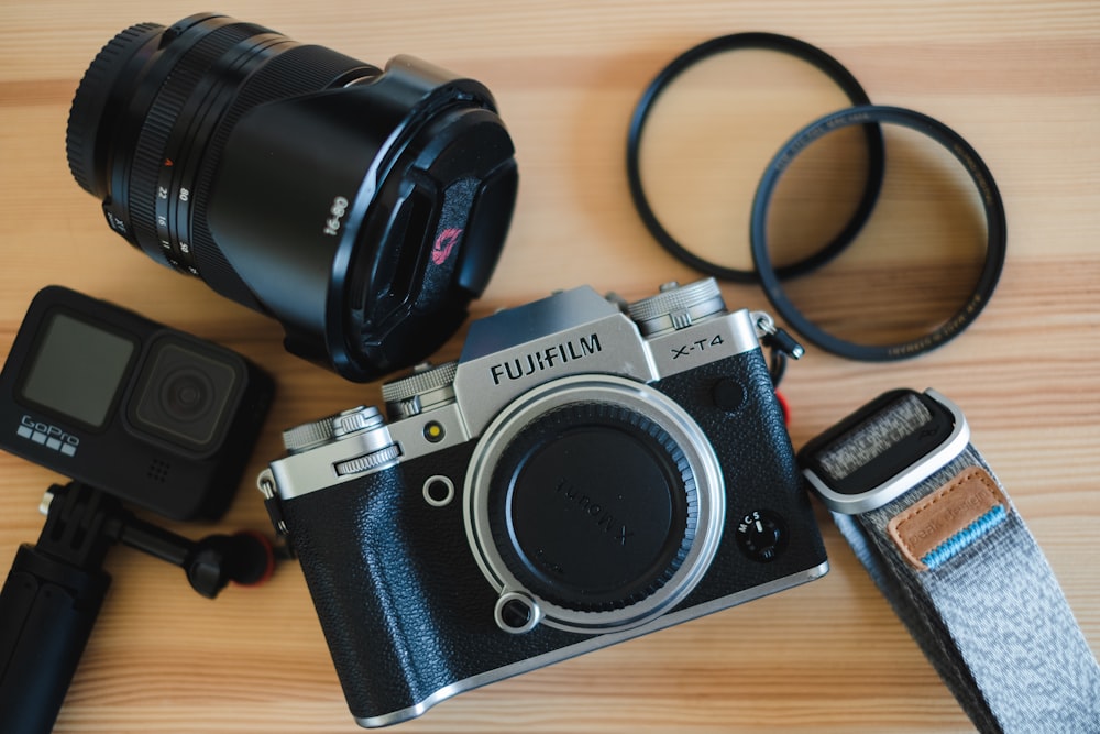 black and silver canon dslr camera on brown wooden table