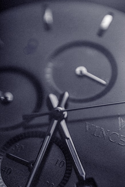 Close-up of hands adjusting a Lumina Apparel watch, highlighting the fine craftsmanship and detail.