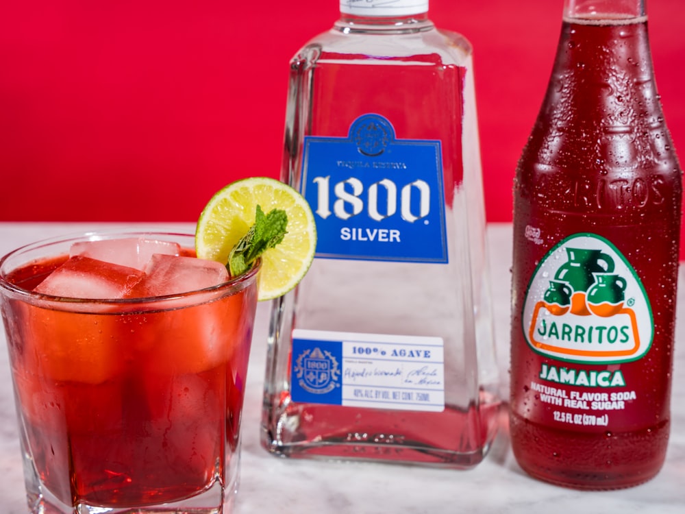 clear glass bottle with red liquid