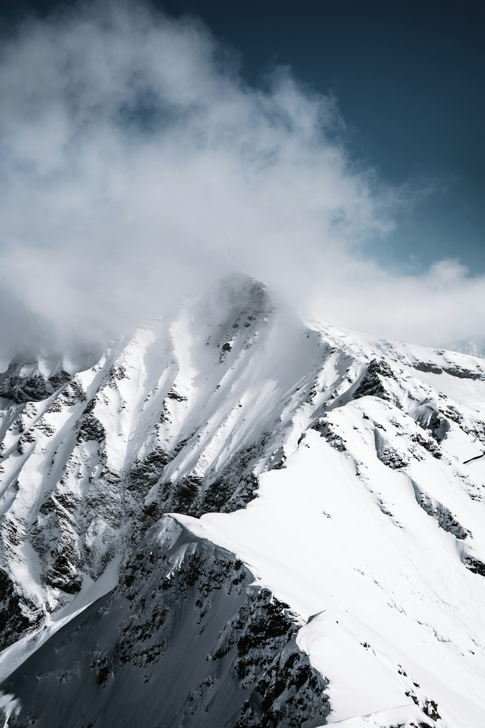 montanha coberta de neve sob o céu azul durante o dia