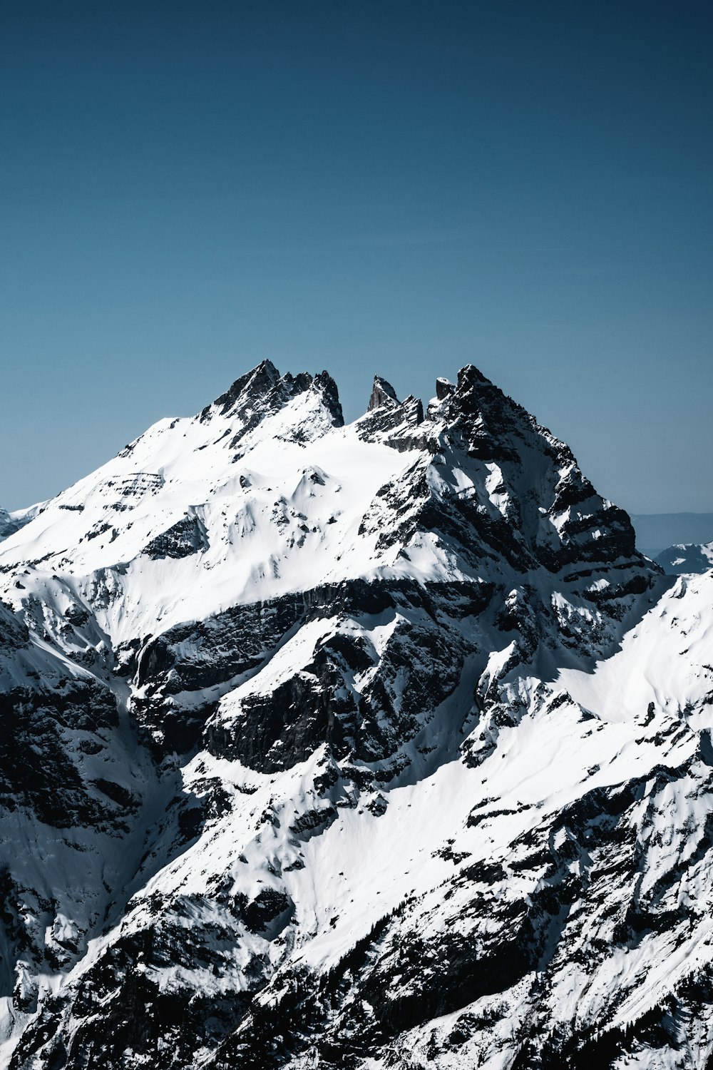 snow covered mountain under blue sky during daytime