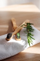 A bamboo toothbrush holder set displayed on a bathroom counter with natural light.