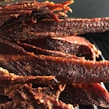 An assortment of beef jerky flavors, highlighting the sweet and spicy theme.