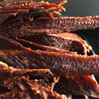 An assortment of beef jerky flavors, highlighting the sweet and spicy theme.