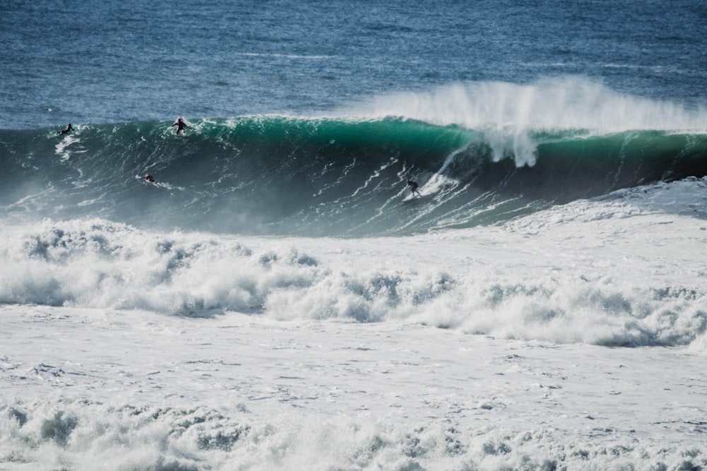 person surfing on sea waves during daytime