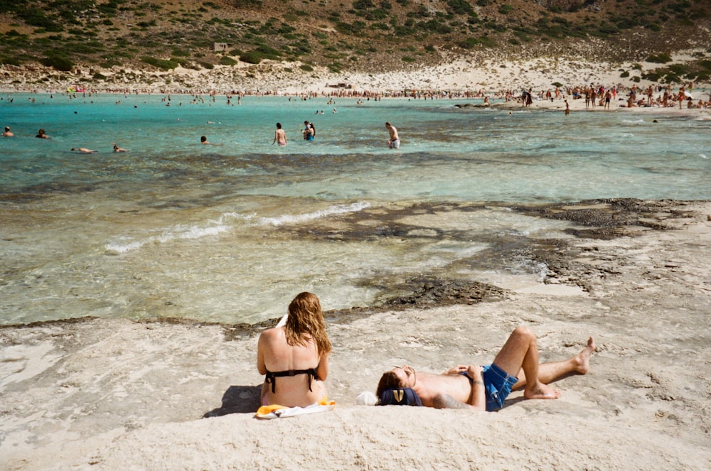 woman in yellow bikini lying on beach