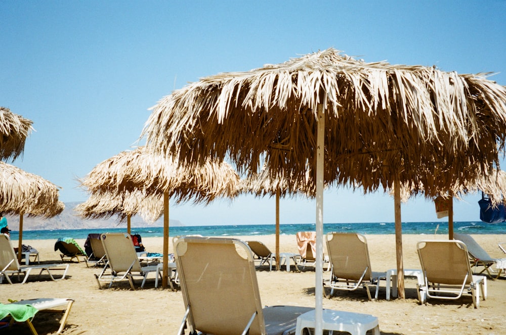 brown nipa hut on beach during daytime