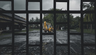 woman in yellow shirt and black pants sitting on brown wooden bench