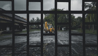 woman in yellow shirt and black pants sitting on brown wooden bench