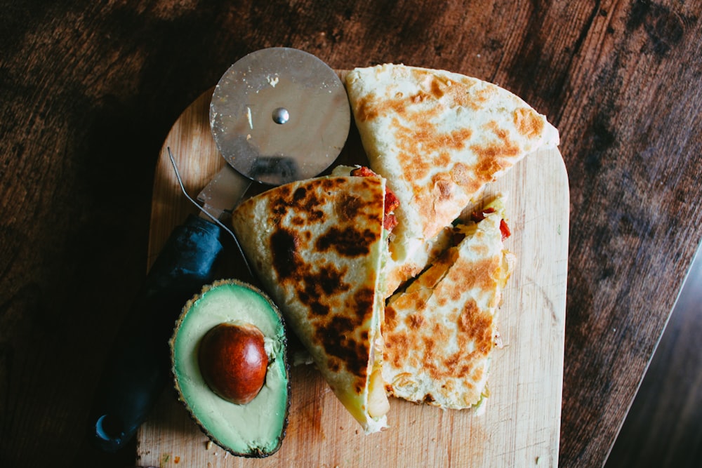 sliced pizza on brown wooden table