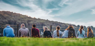 people standing on green grass field during daytime