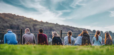 people standing on green grass field during daytime