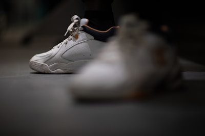 Close-up of a sneaker being carefully hand-washed with foam.