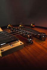 brown guitar headstock on brown wooden table