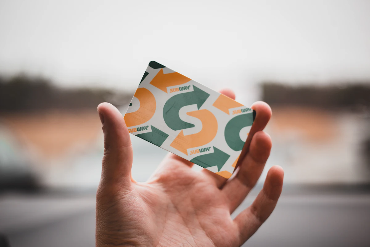 Person holding green and white card