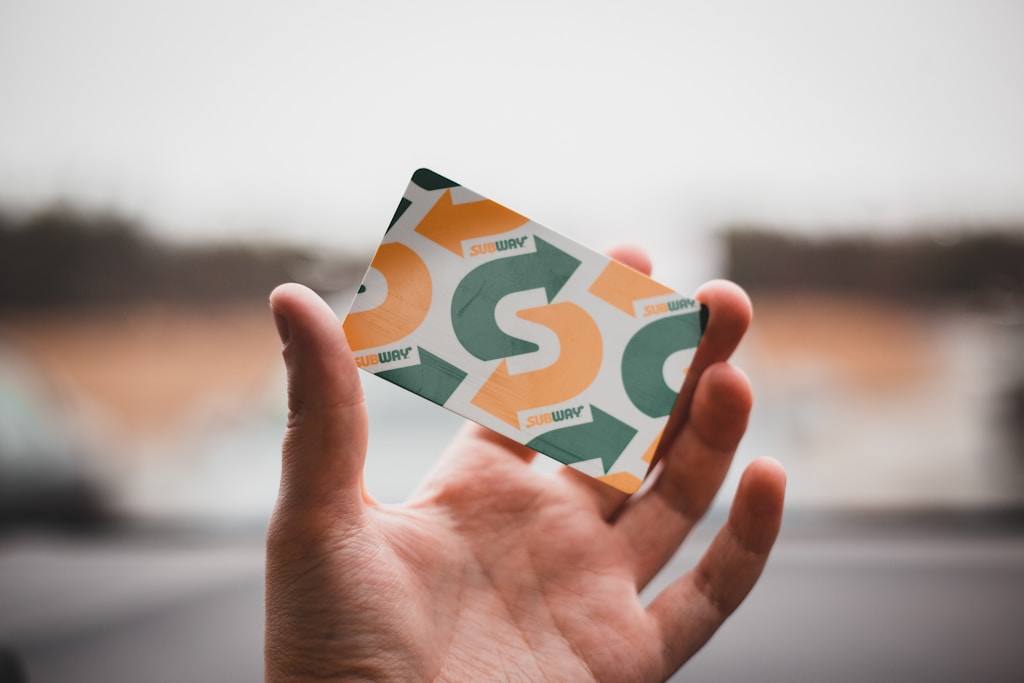 person holding green and white card