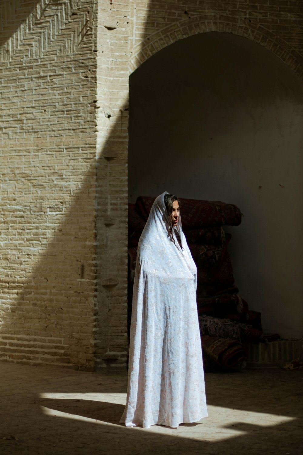 white textile on brown brick wall