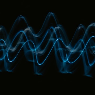 a black background with a blue wave of light