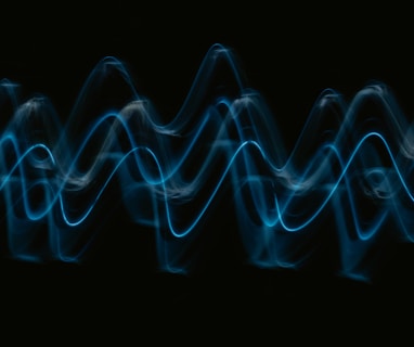 a black background with a blue wave of light