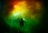 Two scuba divers are underwater surrounded by a vibrant display of colorful light, including shades of green, yellow, and red, which create an almost surreal and otherworldly atmosphere.