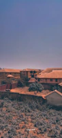 A wide view of a neighborhood with several homes featuring new golden roofs.